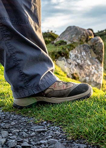 Hiking boot atop a hill