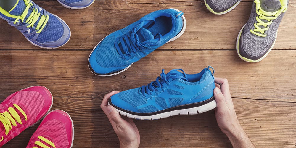 Man holding a pair of running shoes