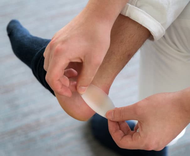 Man applying bandage to blister